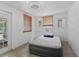 Bright bedroom featuring wood blinds, white walls, and a minimalist bed setup at 1081 Se 174Th Ter, Silver Springs, FL 34488