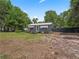 Cozy gray home featuring a white door, sunshades, black fence, and a well-manicured front yard at 1081 Se 174Th Ter, Silver Springs, FL 34488