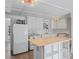 Functional kitchen featuring modern appliances, white cabinets, and an island at 1081 Se 174Th Ter, Silver Springs, FL 34488