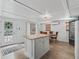 Cozy kitchen with an island, wood countertops, a dining table, and white cabinets at 1081 Se 174Th Ter, Silver Springs, FL 34488