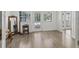 Bright, open living room with hardwood floors, white walls, and natural light at 1081 Se 174Th Ter, Silver Springs, FL 34488