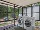 Covered porch featuring laundry machines and offering views of the backyard at 1081 Se 174Th Ter, Silver Springs, FL 34488