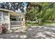 Cozy back porch with brick accents overlooking the paved driveway and manicured backyard at 1104 E Anderson St, Orlando, FL 32801