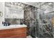 Sleek bathroom features marble accent wall, wood vanity, and glass shower at 1104 E Anderson St, Orlando, FL 32801