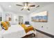 Bedroom featuring a modern bed, TV, ceiling fan and en-suite bathroom at 1104 E Anderson St, Orlando, FL 32801