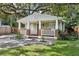 Charming home featuring a cozy front porch with brick accents, flower boxes and a landscaped front yard at 1104 E Anderson St, Orlando, FL 32801