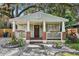 Charming home featuring a cozy front porch with brick accents, flower boxes and a landscaped front yard at 1104 E Anderson St, Orlando, FL 32801