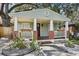 Charming home featuring a cozy front porch with brick accents, flower boxes and a landscaped front yard at 1104 E Anderson St, Orlando, FL 32801