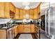 Charming kitchen with stainless steel appliances, wooden cabinets, and dark countertops at 1104 E Anderson St, Orlando, FL 32801