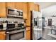 Modern kitchen featuring stainless steel appliances and a view of the adjacent living area at 1104 E Anderson St, Orlando, FL 32801