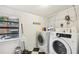Bright laundry room featuring a washer, dryer, and ample storage space at 1104 E Anderson St, Orlando, FL 32801