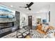 Living room featuring a fireplace, TV, and modern decor, with view of front door and desk space at 1104 E Anderson St, Orlando, FL 32801