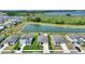 Aerial view of homes near lake, showcasing community layout, landscaping, and scenic waterfront at 1158 Oak Valley Dr, Auburndale, FL 33823