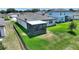 Aerial view of backyard featuring a screened patio, green lawn, and a fence line providing privacy at 1158 Oak Valley Dr, Auburndale, FL 33823