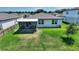 A well-manicured backyard with a screened patio and green grass offers the ideal outdoor space at 1158 Oak Valley Dr, Auburndale, FL 33823