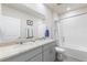 Bathroom featuring double sinks, granite countertops and a walk-in shower at 1158 Oak Valley Dr, Auburndale, FL 33823