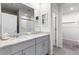 Bright bathroom features a double vanity with granite countertops and a walk-in shower at 1158 Oak Valley Dr, Auburndale, FL 33823