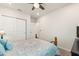 The bedroom features a black metal frame bed with blue pillows and a ceiling fan at 1158 Oak Valley Dr, Auburndale, FL 33823