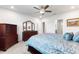 Spacious bedroom with a ceiling fan, a large dresser with mirror, and a comfortable queen size bed at 1158 Oak Valley Dr, Auburndale, FL 33823