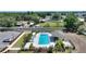 Aerial shot of a pristine community pool with ample seating, landscaping, and clubhouse at 1158 Oak Valley Dr, Auburndale, FL 33823