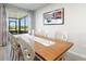 Beautiful dining area with an elegant wooden table, seating six, and sliding glass doors at 1158 Oak Valley Dr, Auburndale, FL 33823