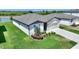 Well-maintained one-story home with a two-car garage, fresh landscaping, and a lush green lawn at 1158 Oak Valley Dr, Auburndale, FL 33823