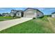Well-maintained one-story home featuring a two-car garage and a sprawling green lawn at 1158 Oak Valley Dr, Auburndale, FL 33823