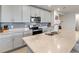 Modern kitchen featuring gray cabinets, granite countertops, stainless steel appliances, and tile backsplash at 1158 Oak Valley Dr, Auburndale, FL 33823