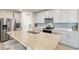 Modern kitchen featuring stainless steel appliances, gray cabinets, a spacious island, and a stylish backsplash at 1158 Oak Valley Dr, Auburndale, FL 33823