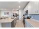 Modern kitchen featuring gray cabinets, granite countertops, stainless steel appliances, and a center island at 1158 Oak Valley Dr, Auburndale, FL 33823