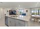 Modern kitchen island with granite countertops is open to the living and dining areas at 1158 Oak Valley Dr, Auburndale, FL 33823
