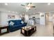 Open-concept living area with a comfortable blue sofa, modern kitchen, and stylish decor at 1158 Oak Valley Dr, Auburndale, FL 33823