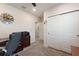 Office space with neutral carpet, a large clock, and built-in white closet with sliding doors at 1158 Oak Valley Dr, Auburndale, FL 33823