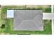 Aerial view of a home's dimensional shingle roof, with gutters and downspouts, surrounded by green grass at 1158 Oak Valley Dr, Auburndale, FL 33823