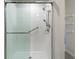 Modern shower with glass doors, dual shower heads, and a convenient grab bar at 1158 Oak Valley Dr, Auburndale, FL 33823