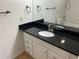 Bathroom featuring an undermount sink, black granite countertop, and black fixtures at 13226 Galicia St # 103, Orlando, FL 32824