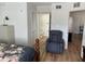 Bedroom featuring a reading chair, wood laminate flooring and ensuite bathroom access at 13226 Galicia St # 103, Orlando, FL 32824