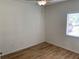 This bedroom features hardwood floors, a ceiling fan, and a window for natural light at 13226 Galicia St # 103, Orlando, FL 32824