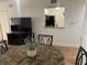 Cozy dining area next to living room featuring marble-top table, adjacent to a pass-through to the kitchen at 13226 Galicia St # 103, Orlando, FL 32824