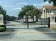Gated community entrance with manicured landscaping, providing security and curb appeal at 13226 Galicia St # 103, Orlando, FL 32824