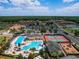 Aerial view showcases the community's recreational amenities, including pools, tennis courts, and verdant landscaping at 1416 Lexington Ave, Davenport, FL 33837