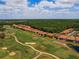 An aerial view showcases homes alongside a golf course, offering a blend of residential comfort and recreational access at 1416 Lexington Ave, Davenport, FL 33837