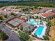 Aerial view highlighting the community's pool, tennis courts, playground, and vibrant landscaping, perfect for recreation at 1416 Lexington Ave, Davenport, FL 33837