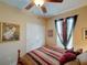 Cozy bedroom featuring a bed with decorative pillows and a striped bedspread and a window with curtains at 1416 Lexington Ave, Davenport, FL 33837