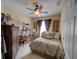 Comfortable bedroom with neutral tones, featuring a bed with plush pillows, and a ceiling fan for added comfort at 1416 Lexington Ave, Davenport, FL 33837