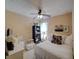 Well-lit bedroom featuring a ceiling fan, white furnishings, and a cozy bed with white and colorful pillows at 1416 Lexington Ave, Davenport, FL 33837