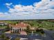 The community's clubhouse overlooks a meticulously manicured golf course, lush greenery, and serene water features at 1416 Lexington Ave, Davenport, FL 33837