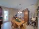 Inviting dining room featuring a wood table, chairs, and a large cabinet with decorative accents and an adjacent exterior door at 1416 Lexington Ave, Davenport, FL 33837
