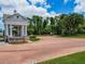 Welcoming entrance to the community, featuring a brick-paved road, lush greenery, and elegant signage at 1416 Lexington Ave, Davenport, FL 33837