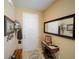 Welcoming entryway with stylish decor, including a decorative table, mirror, and unique wall art pieces at 1416 Lexington Ave, Davenport, FL 33837